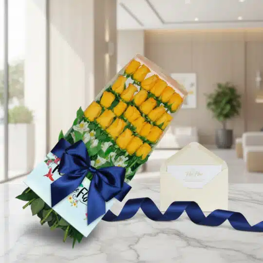 Caja de 24 rosas amarillas frescas y vibrantes, con follaje verde, sobre una mesa de mármol. Incluye una tarjeta de regalo el